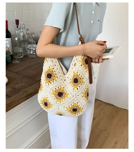 Close-up of handmade sunflower crochet tote bag with brown leather strap detail