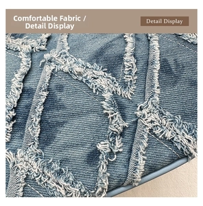 Macro detail of quilted denim fabric with frayed edges and distressed rhombus texture