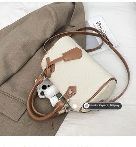 Internal view of beige Boston bag showing spacious capacity for phone and cosmetics