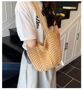 Detail of hand-woven hobo shoulder bag showing natural beige cotton rope texture