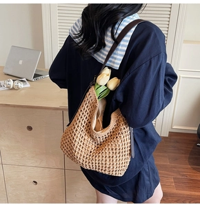 Close-up of woven mesh texture and leather strap on a beige handmade tote bag