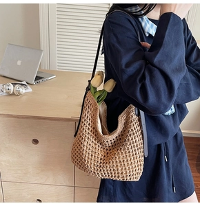 Detail of hand-woven cotton shoulder bag with leather strap and decorative tulips