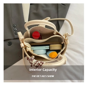 Interior view of beige bucket bag showing capacity for phone, lipstick, and cosmetics