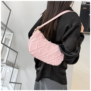 Detailed view of pink quilted denim hobo bag showing frayed edge texture and gold hardware