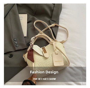Macro shot of off-white woven bucket bag with silk scarf and fashion leather tag