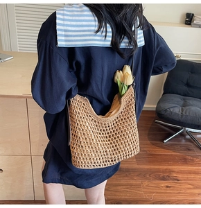 Detailed weave pattern of cotton rope tote with flowers and slim brown strap