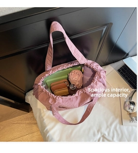 Top-down view of spacious nylon tote interior holding laptop, umbrella and essentials