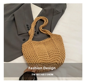 Detail showing handwoven texture and long shoulder straps of this khaki tote bag
