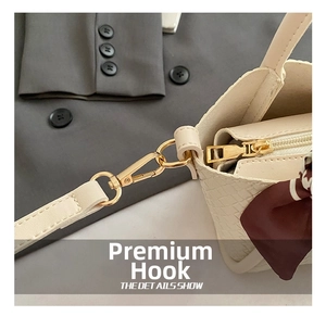Detail of cream woven bucket bag with gold hardware and elegant striped silk scarf accent