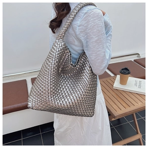 Vue détaillée du grand sac cabas tressé argenté montrant la texture et la capacité