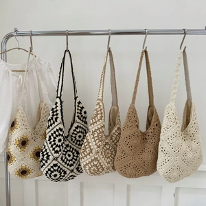 Macro detail of hand-knitted tote bag showing crochet patterns and cotton lining