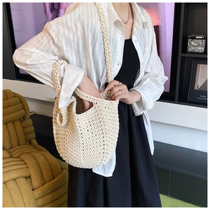 Detailed texture of off-white hand-woven tote bag showing the thick cotton rope craftsmanship