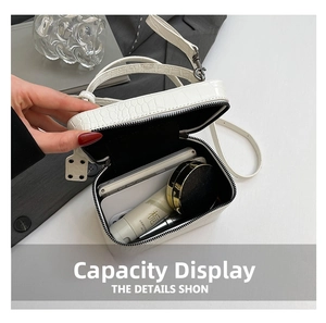 Detail view of cream crocodile pattern bag showing spacious interior capacity for cosmetics