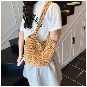 Detail of hand-woven crochet tote bag showing V-shaped texture and soft camel cotton knit
