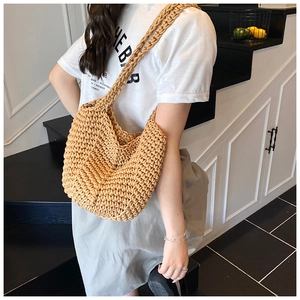 Detail of hand-woven tote bag with wave texture and integrated strap for summer