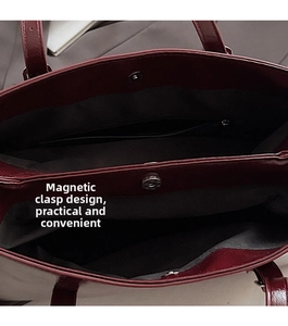 Detailed view of the reddish-brown tote bag with magnetic snap closure and inner pocket