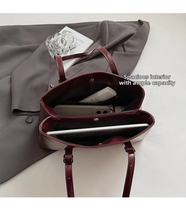 Interior view of burgundy tote bag with multiple compartments for tablet and essentials