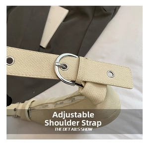 Detail view of adjustable strap with silver buckle on beige lychee texture shoulder bag