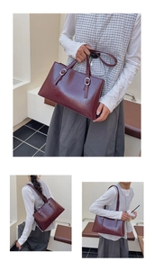 Detail view of burgundy leather tote bag with double handles and silver metallic buckles