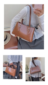 Detail view of brown glossy leather tote bag with silver buckles and spacious double layers