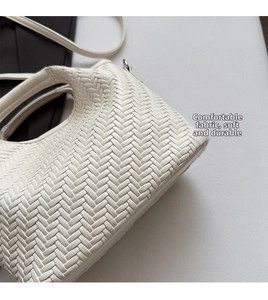 Close-up of the milk-white woven leather texture on a stylish large handbag