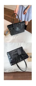 Close-up of black textured faux leather tote bag with matching small card pouch