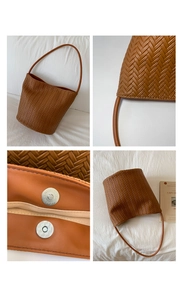 Detail of brown woven bucket bag showing fine cross-weave texture and magnetic closure