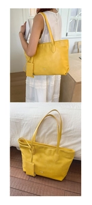 Bright yellow leather tote bag detail with matching zipper pouch for daily commuting