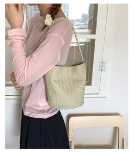 Detailed view of the woven V-pattern texture on a minimalist sage green tote bag