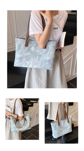 Detail view of light blue marble tote bag with brown straps and spacious interior