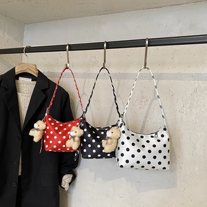 Chic polka dot shoulder bag with cute bear pendant, stylish underarm bag for women daily use.