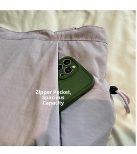 Detail view of a light purple tote bag zipper pocket showing spacious internal storage