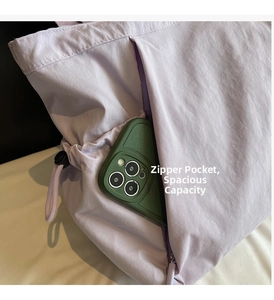 Close-up of a lavender tote bag featuring a hidden side zipper pocket for phone storage