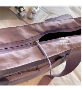 Close-up of the smooth purple nylon tote bag zipper with a high-quality metal puller