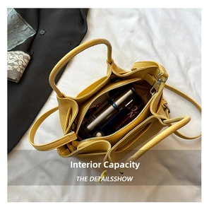 Internal view of yellow pebbled leather bucket bag showing compartments and large capacity