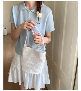 Minimalist white woven bucket bag styled with a summer casual outfit for a clean look