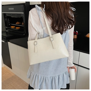Detail of adjustable silver buckle on off-white tote bag strap for shoulder length adjustment
