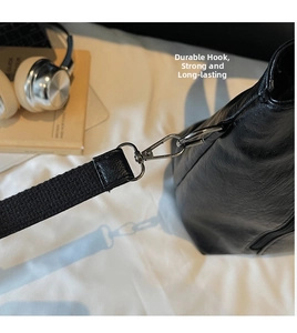 Close-up of durable silver metal swivel hook and black lychee grain leather tote bag strap