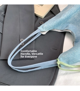 Close-up of light blue denim tote bag with sparkling rhinestones and woven handles