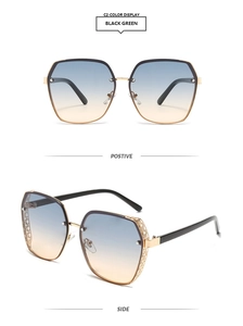 Detail view of gold metal frames and blue-orange gradient lenses on oversized sunglasses