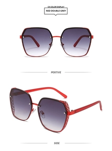 Detail view of red oversized geometric sunglasses featuring unique镂空metal mesh temples