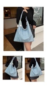 Detail of light blue denim tote bag featuring glitter texture and white tulip charm