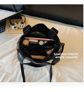 Detailed view of large black tote bag interior showing spacious compartments and pockets