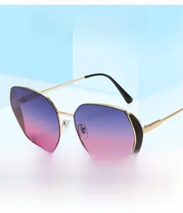 Detail of oversized butterfly sunglasses with gradient purple lenses and gold metal frame