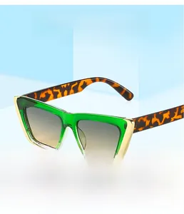 Detail of cat eye sunglasses featuring green frames and tortoiseshell temples