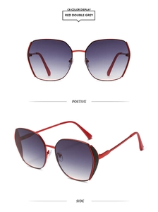 Detail view of red oversized geometric sunglasses with black glitter hinge and gradient lens