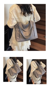 Detail of grey pleated leather tote bag with vertical zipper on wooden stairs