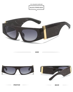 Lunettes de soleil à monture marbre noir, verres dégradés et détails en métal doré
