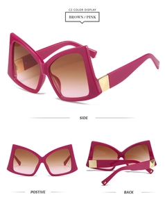 Detail view of pink butterfly sunglasses with gradient lenses and gold metal accents