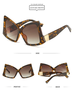 Macro view of oversized leopard print butterfly sunglasses with gold metal hinges